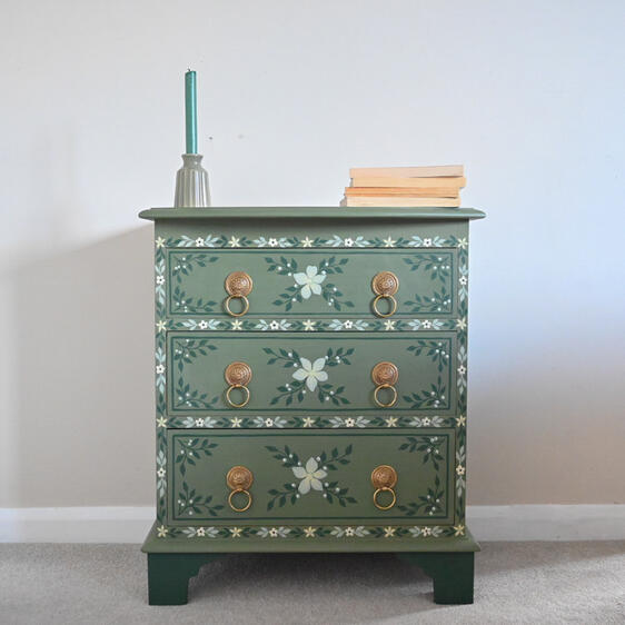 Hand-painted green floral chest of drawers with brass ring handles, vintage style wooden bedside table.