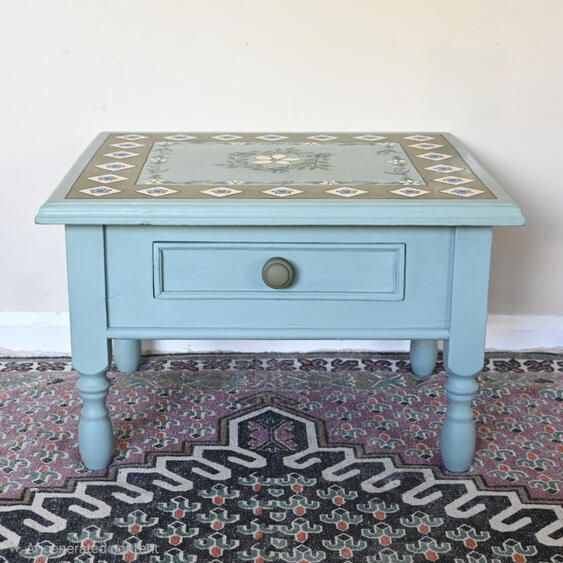 Duck egg blue hand painted coffee table A mini coffee table with one drawer painted in blue and green with a folky floral design