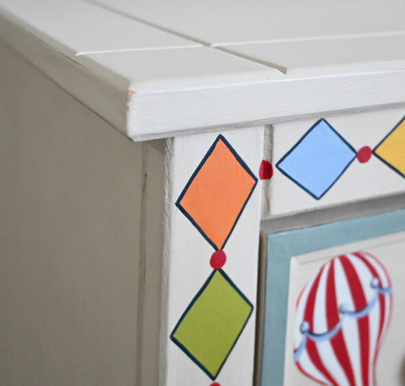 Boys painted vintage cabinet Close-up of a hand-painted children’s wooden drawer featuring a red-and-white hot-air balloon