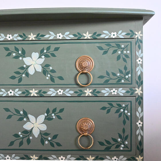 Hand-painted green floral chest of drawers with brass ring handles, vintage style wooden bedside table.