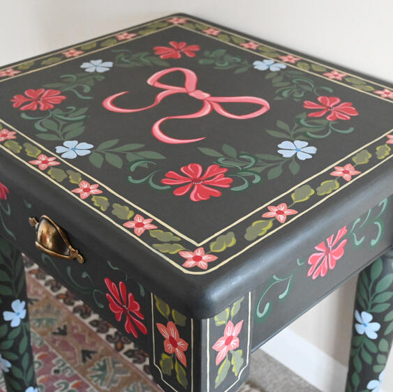 Close up of dark grey and colourful floral painted table