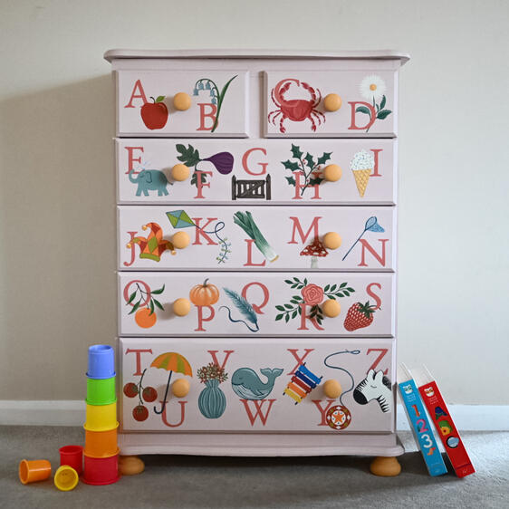 Hand-painted kids alphabet dresser with colorful A to Z illustrations, perfect nursery furniture chest of drawers for children’s room decor.