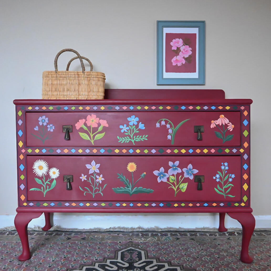 Burgandy wildflower chest of drawers A vintage two drawer chest painted in burgandy with colourful wildflowers and pattern